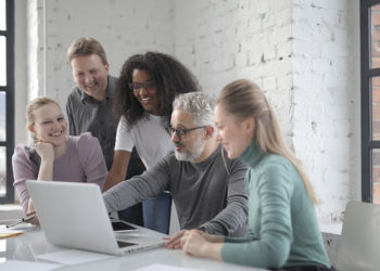 smiling-group-of-colleagues-discussing-project-in-office-3860819_pexels_1000